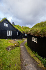 Scenic path between traditional black turf-roofed houses