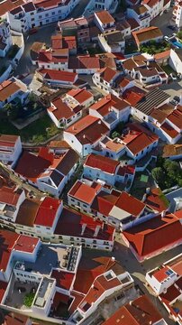  Aerial view of small village with windmill and picturesque rooftops, Odeceixe, Portugal