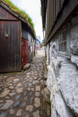Charming cobblestone alley with historic wooden and stone houses