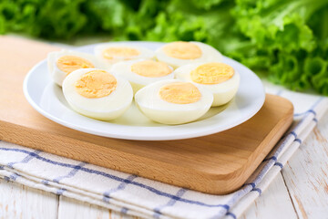 boiled chicken eggs in a plate on a white table, selective focus.