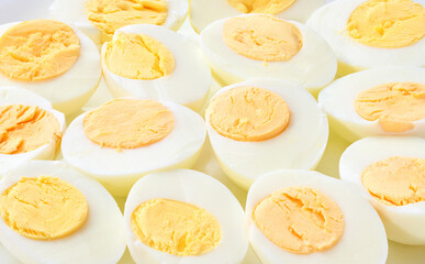 A close up of hard boiled chicken eggs. boiled chicken eggs peeled and cut in half close up.