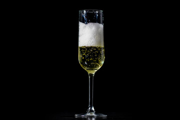 Champagne splash. Pour of sparkling wine. Champagne glass on black background. Sparkling wine. Wineglass with champagne. Splash of champagne for festive celebration. Pouring sparkling wine.