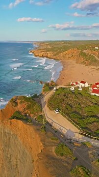  Aerial view of small village with windmill and picturesque rooftops, Odeceixe, Portugal