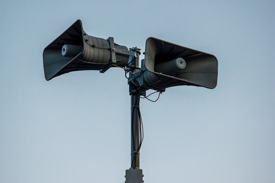 Air raid warning loudspeaker system on metal pole outdoors