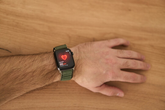 A square smartwatch on a man's hand close up. Heart rate measurement on watch. High quality photo