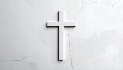 Minimalist white wooden cross against a textured cracked wall with subtle lighting