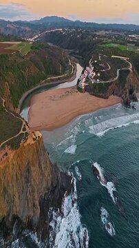  Aerial view of small village with windmill and picturesque rooftops, Odeceixe, Portugal
