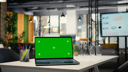 Mockup screen on laptop running chroma key in an empty business workspace, human resources department office space prepared for hiring process, interviews and career development. Chroma key.