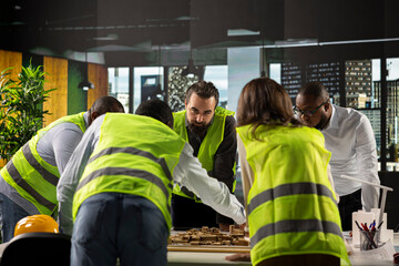 Colleagues in real estate and architecture working together on project design and development. The diverse staff focuses on innovation, urban planning, and sustainable property investment.