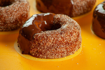 Chocolate sugared with melted icing and filling brioche doughnuts Closeup.