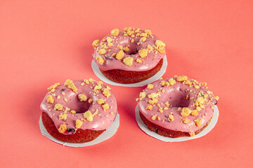 Three Berry filled brioche doughnuts with crushed biscuit topping.