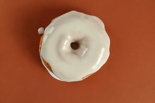Cream topping and filled brioche doughnut coffee flavour closeup top view.