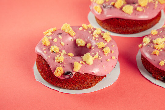 Berry filled brioche doughnuts with crushed biscuit topping closeup.