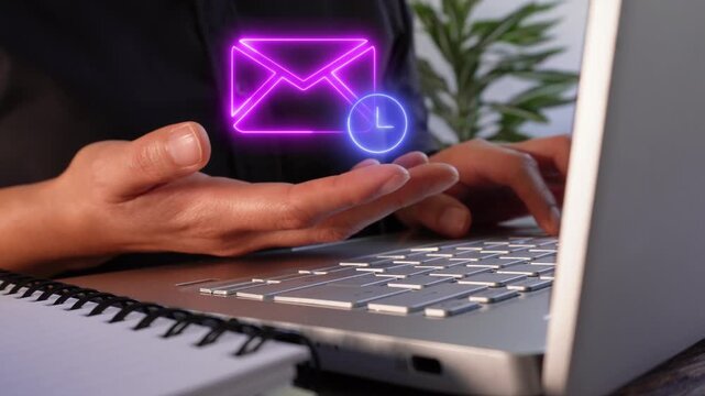 Email scheduled for automatic delivery. A person working on their computer while holding a virtual icon of a mail envelope and a clock.