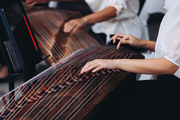 Traditional Korean folk musical instrument Gayageum, female orchestra band performing concert on Kayagum in of Seoul, South Korea, wooden zither with 12 strings, Koto or Guzheng live music performance