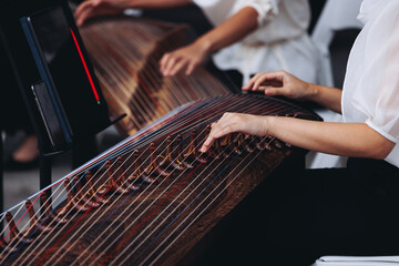 Traditional Korean folk musical instrument Gayageum, female orchestra band performing concert on Kayagum in of Seoul, South Korea, wooden zither with 12 strings, Koto or Guzheng live music performance
