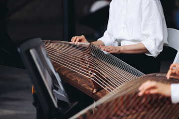 Traditional Korean folk musical instrument Gayageum, female orchestra band performing concert on Kayagum in of Seoul, South Korea, wooden zither with 12 strings, Koto or Guzheng live music performance