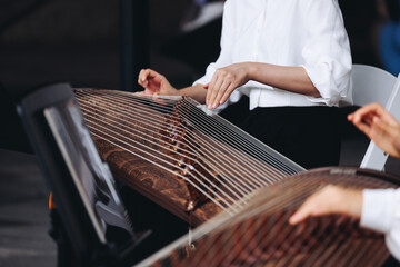 Traditional Korean folk musical instrument Gayageum, female orchestra band performing concert on Kayagum in of Seoul, South Korea, wooden zither with 12 strings, Koto or Guzheng live music performance