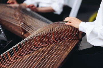 Traditional Korean folk musical instrument Gayageum, female orchestra band performing concert on Kayagum in of Seoul, South Korea, wooden zither with 12 strings, Koto or Guzheng live music performance