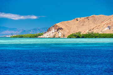 Fototapeta premium Stunning turquoise sea of Komodo National Park with calm waves and tropical scenery