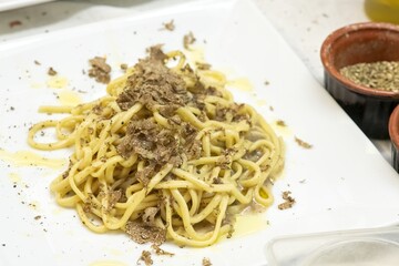 Traditional Italian spaghetti al tartufo served hot with aromatic truffle flavor and fresh...
