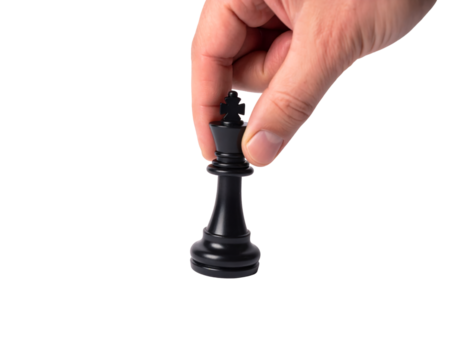 Close-up of a hand using a precision grip to lift or place a black chess King piece by its cross top, showing a strategic move, isolated against a light gray background.