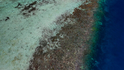 Aerial drone view of Pulau Karangan Island with pristine beach and turquoise sea in Komodo National Park