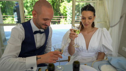 Happy newlyweds enjoying the festive party at the villa surrounded by loved ones and relatives