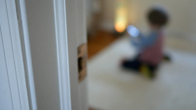 Blurry Toddler Is Looking at Smartphone - Parenting Concept