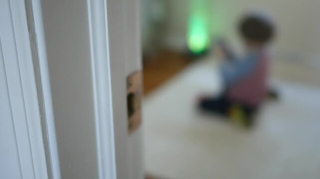 Blurry Toddler Is Looking at Smartphone - Parenting Concept