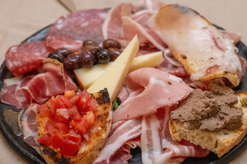 Traditional Italian charcuterie and cheese board served with fresh bread and garnishes