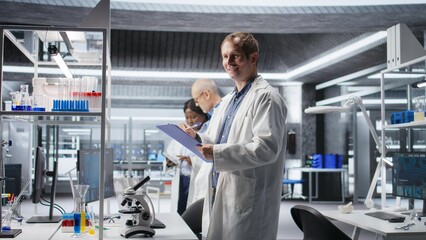 Male scientific expert reviewing samples in high tech laboratory setting, medical discovery process...