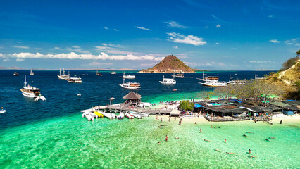 Obraz premium Scenic aerial panorama of Pulau Kelor Komodo showing crystal sea and snorkelers underwater