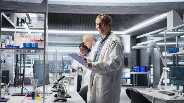 Male scientific expert reviewing samples in high tech laboratory setting, medical discovery process involves biotechnology research and molecular science. Healthcare data innovation.