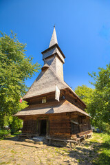 Saint Parascheva Church, a historical wooden monument from the 1700s, standing in a traditional cemetery in Maramures region of Romania, Romania. vertical view