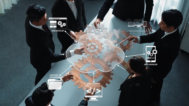 A group of professionals engages in a collaborative meeting focused on web development strategies. Visual aids of gears and digital tools enhance the discussion on technology and solutions. Raster