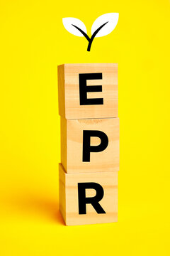 EPR letters on wooden blocks with a sprouting leaf representing extended producer responsibility and circular economy compliance, linking product lifecycle stewardship to sustainable business practice