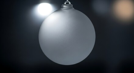 Ethereal Silver Christmas Ornament Suspended in Moody, Bokeh-Lit Darkness.