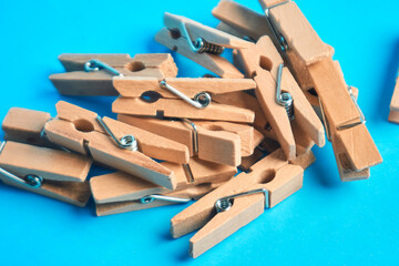 Wooden clothespins scattered as a still life showing organization and the power of simple tools to hold together, symbolizing teamwork and everyday problem solving
