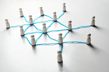 Connected wooden pegs linked by string lines, visualizing network relationships, communication...