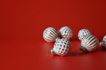Beautiful shiny Christmas tree balls on a red background close-up