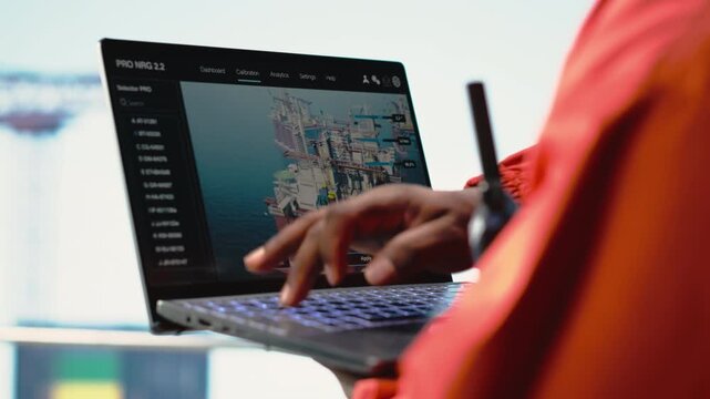 Close up of laptop used by drilling rig worker to monitor infrastructure systems. Offshore installation manager calibrating equipment with notebook device software, camera B