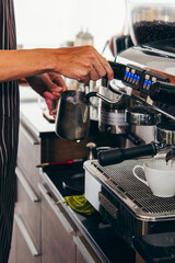 Vertical Horizon Close up hands coffee barista man make hot cup espresso shot from coffee machine. Vertical Cappuccino with milk italian cafe. Close up hands of barista make black hot coffee cup
