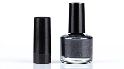 Obraz premium Two cosmetic items: dark colored nail polish bottle and cap.