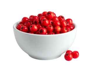 A bowl filled with red berries sits against a stark black background, showcasing their vibrant color and form