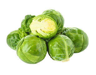 Fototapeta premium Pile of green, leafy Brussels sprouts with one sliced open against a black background, showing internal structure