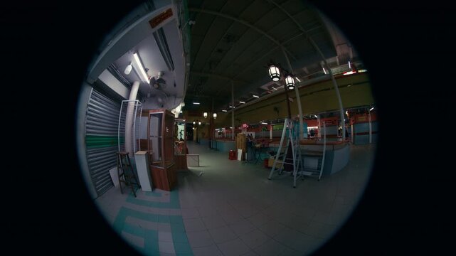 Deserted Chinese Market at Night &ndash; Rows of locked metal shutters in a dark corridor.
