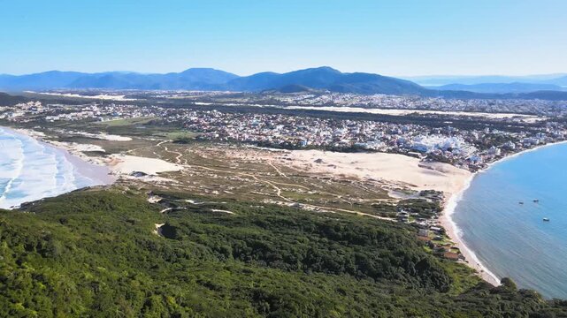 Panoramic aerial view of Santinho Beach and Ingleses Beach in Florian&oacute;polis, Santa Catarina, restinga area and dunes seen from the top of Ingleses Hill on a beautiful sunny day.