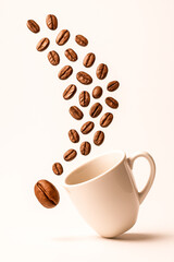 Obraz premium Coffee Beans Flying Out of White Mug in Artistic Motion