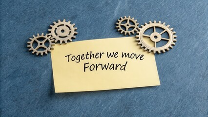 A conceptual image of teamwork with interlocking cogs and an inspirational note reading Together we move Forward